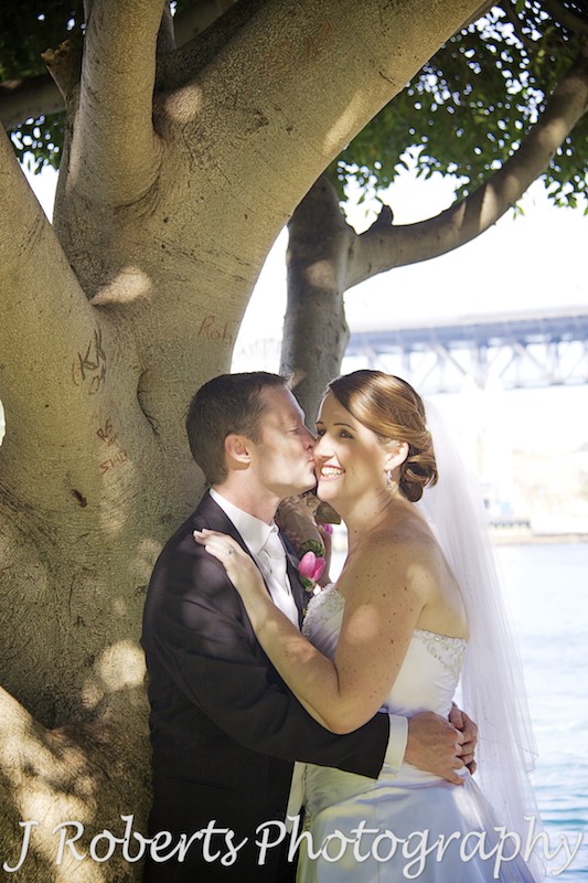 Groom kissing brides cheek - wedding photography sydney